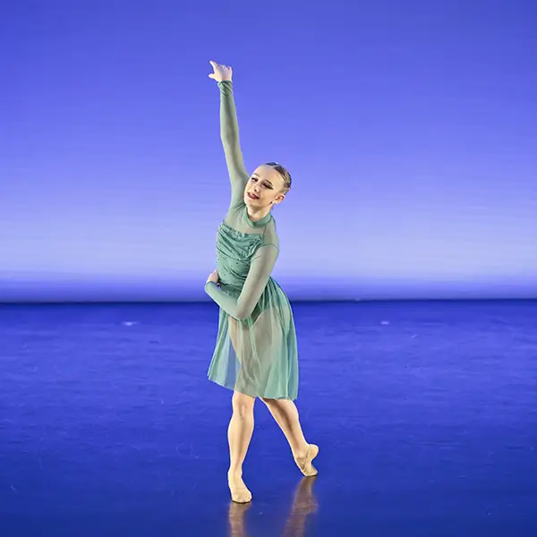 Grace performing in green dress